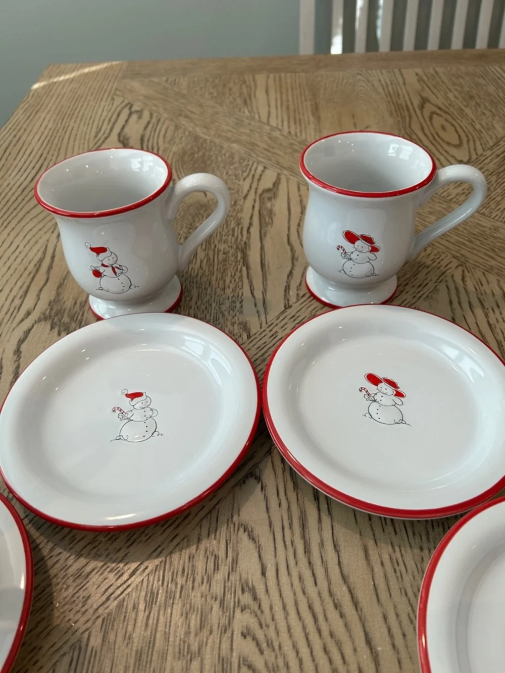 Williams Sonoma White Mugs and dessert plates with Red-Rim Snowman Motif